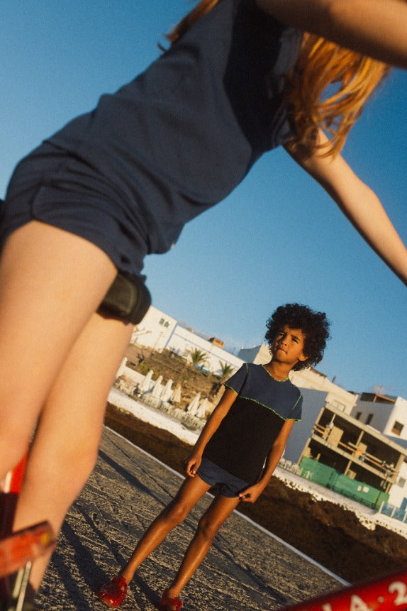 boy and girl both wearing blue cotton track shorts