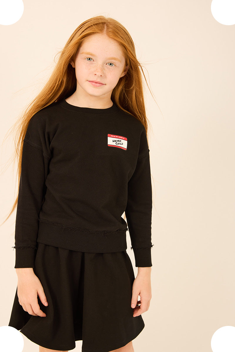 Young girl wearing a long sleeve Tee and matching skirt