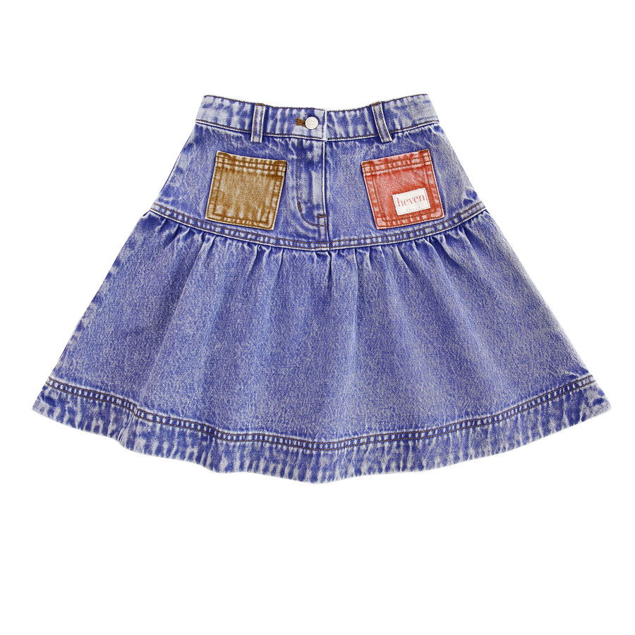 Blue denim skirt with patch details on a white background