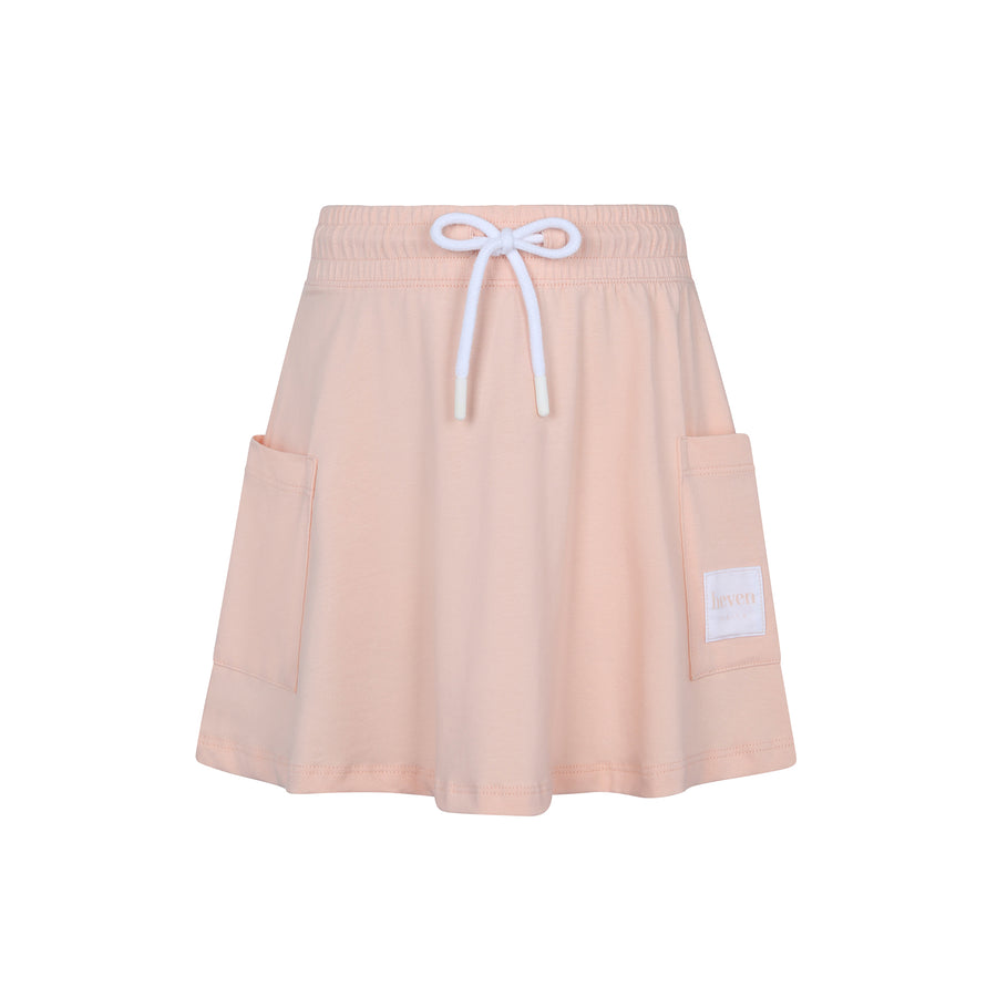Pink skirt with white drawstring and pockets on a white background