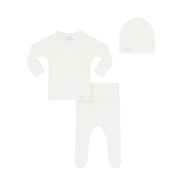White baby outfit with long-sleeve shirt, pants, and hat on a white background