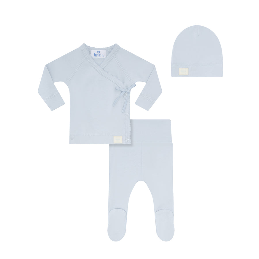 Baby clothing set with long-sleeve shirt, pants, and hat on a white background