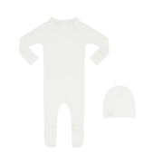 Ivory baby footie and matching beanie on a white background.