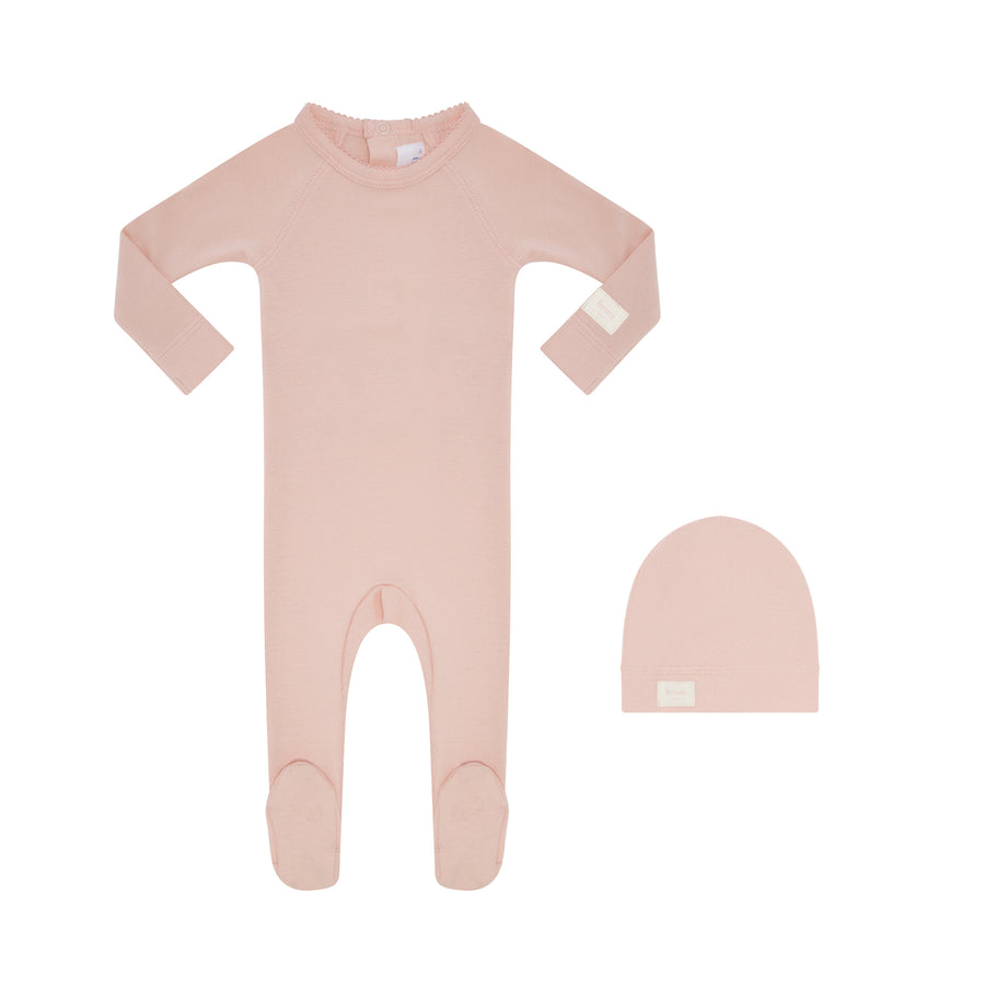 Pink baby onesie and hat set on a white background
