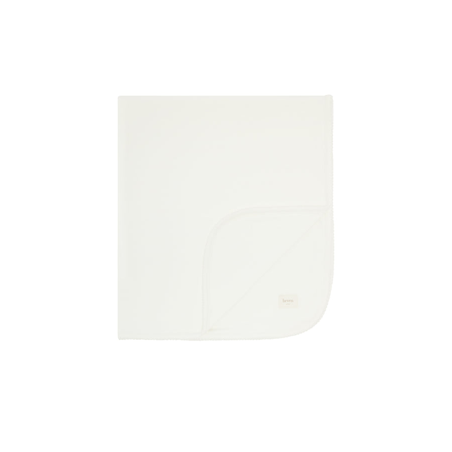 White swaddling blanket folded on a white background