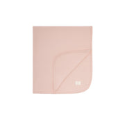Pink baby blanket with a brand label on a white background