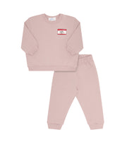 Pink sweatshirt and matching pants on a white background. 