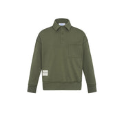 An olive green long-sleeve polo shirt with a collar, three-button placket, and a chest pocket, shown flat on a white background. A small beige brand patch is visible on the lower left sleeve.