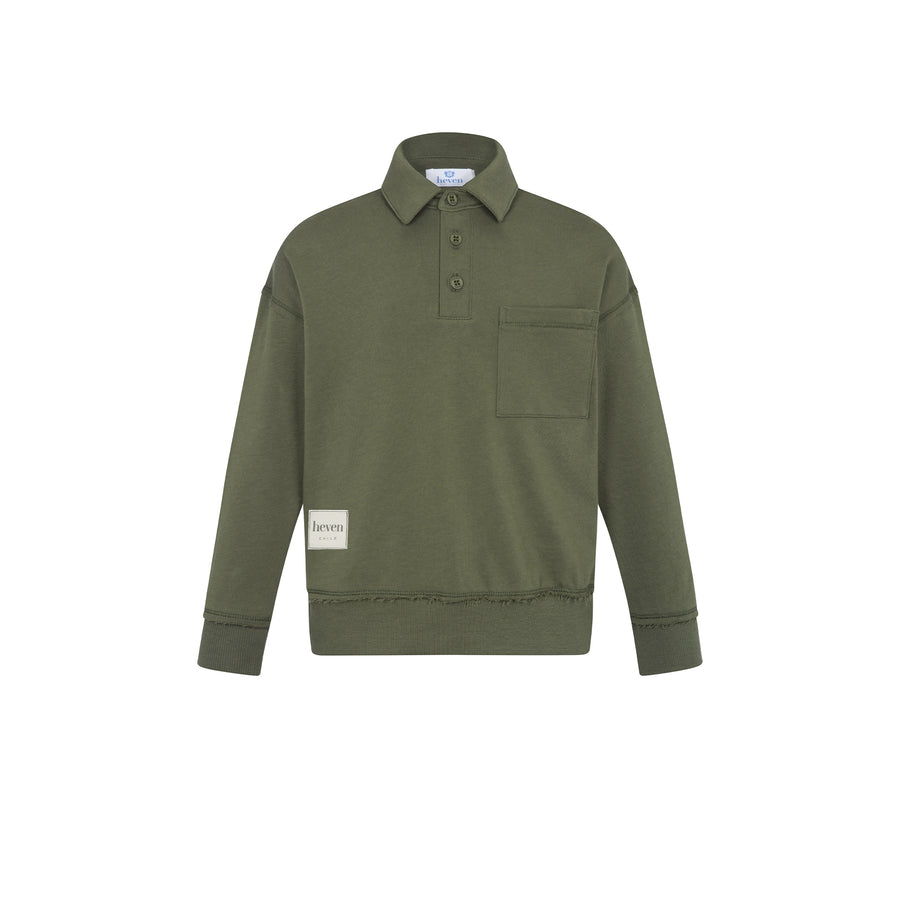 An olive green long-sleeve polo shirt with a collar, three-button placket, and a chest pocket, shown flat on a white background. A small beige brand patch is visible on the lower left sleeve.