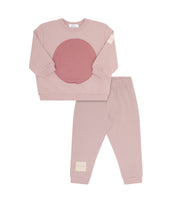 Pink sweatshirt and sweatpants on white background.