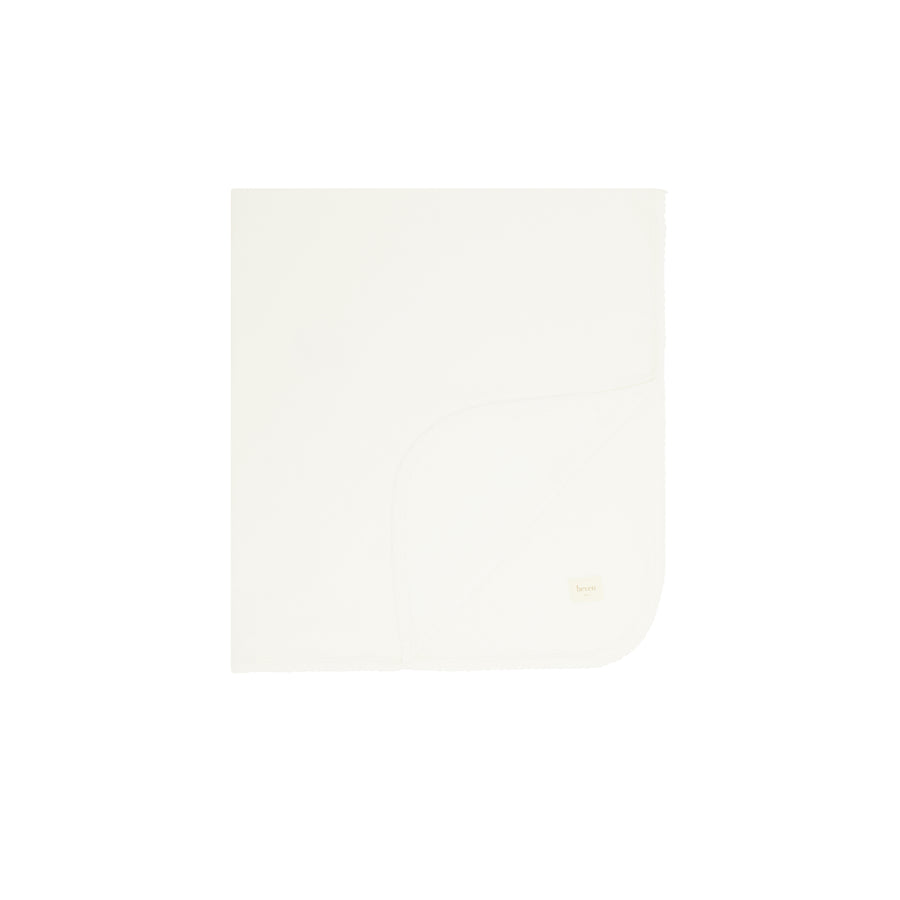 Ivory folded blanket on a white background.