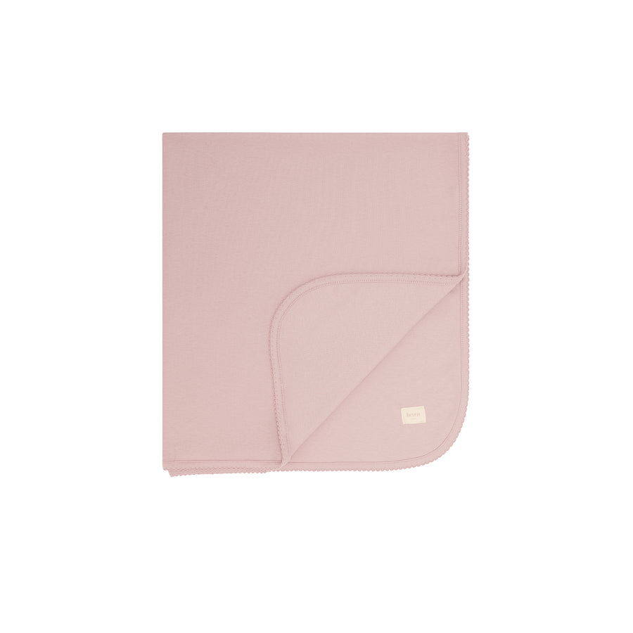 Pink folded blanked on a white background.
