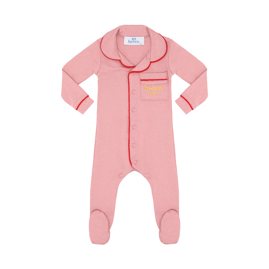 Pink baby onesie with red trim on a white background