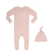 Pink baby onesie and hat set on a white background