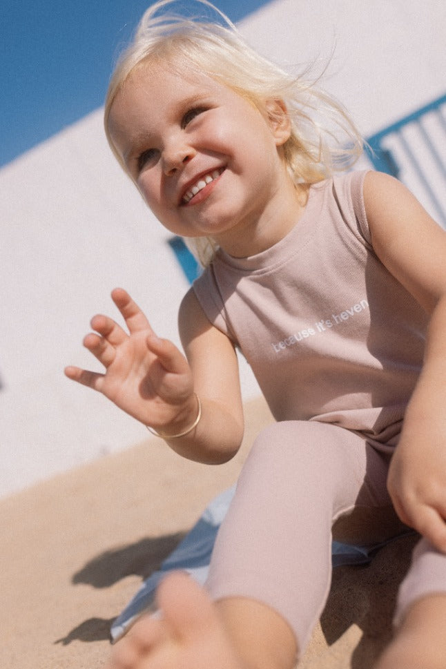girl wearing the pink baby romper